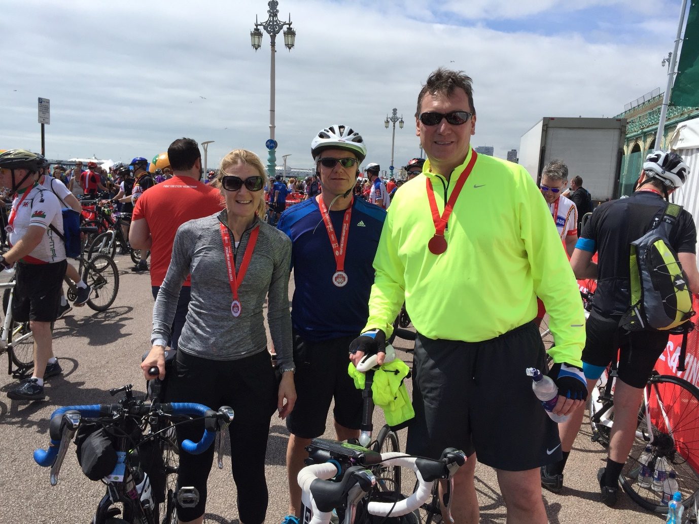 Riders wearing medals among the bikes at the end of the London to Brighton ride