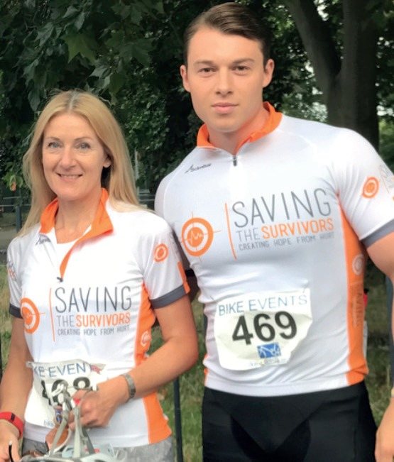 Two riders in Saving the Survivors cycling jerseys