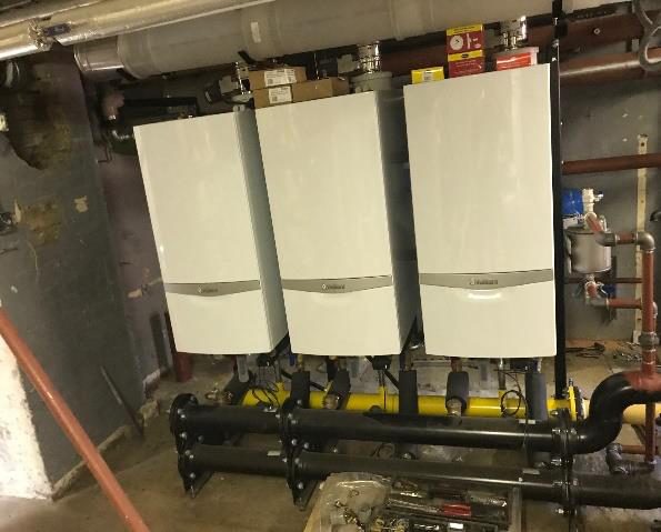 Three new wall-hung boilers on a rig at Chase Side Primary School