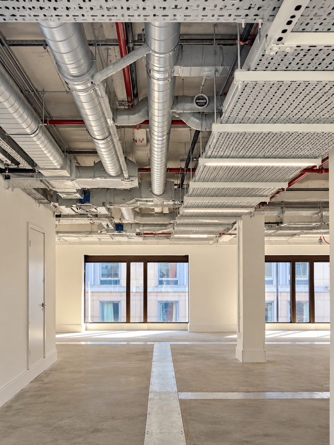 Exposed ductwork and services on the refurbished office floor at 30 City Road