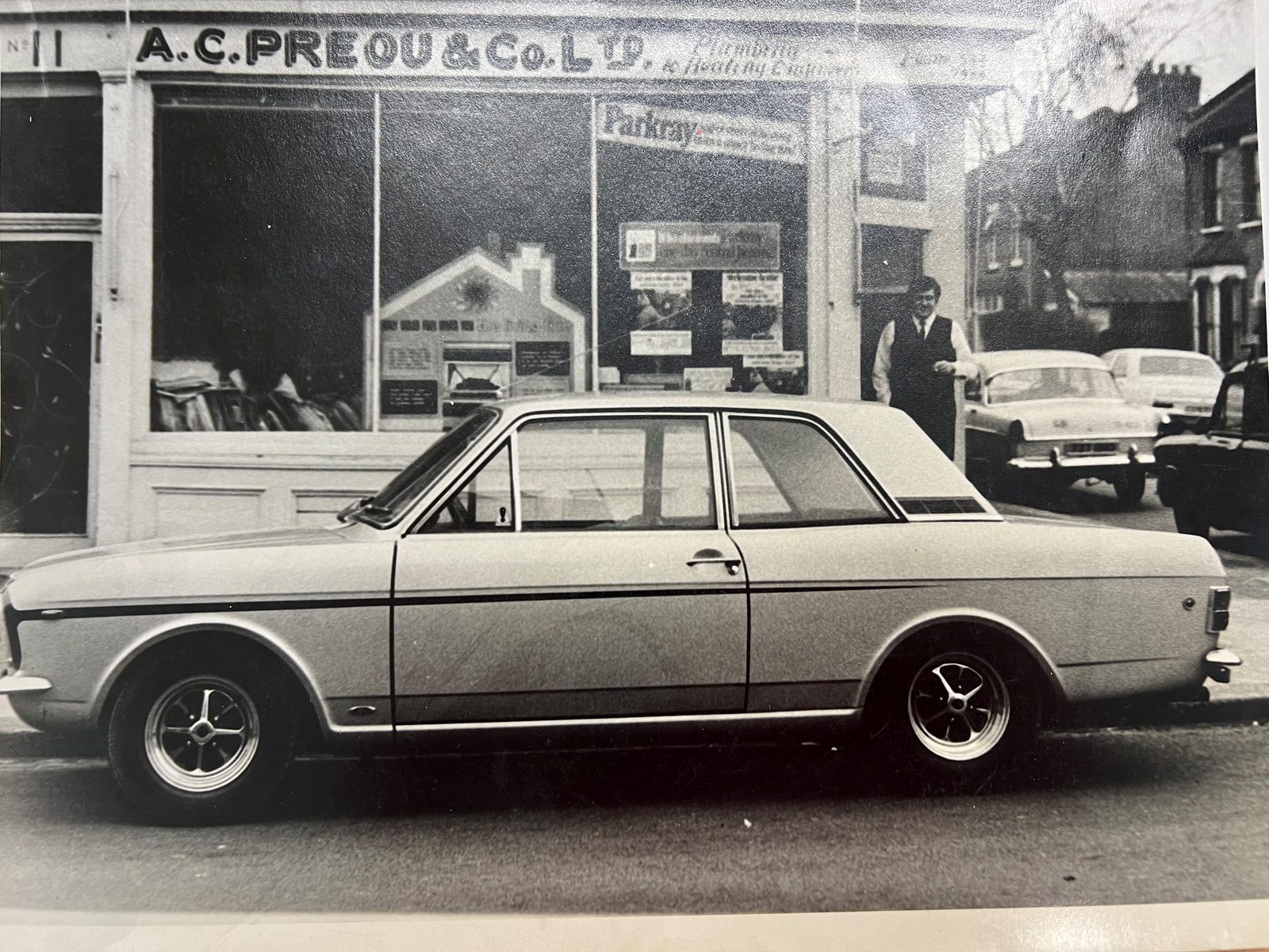 The company's shopfront in the 1960s, with a car parked outside
